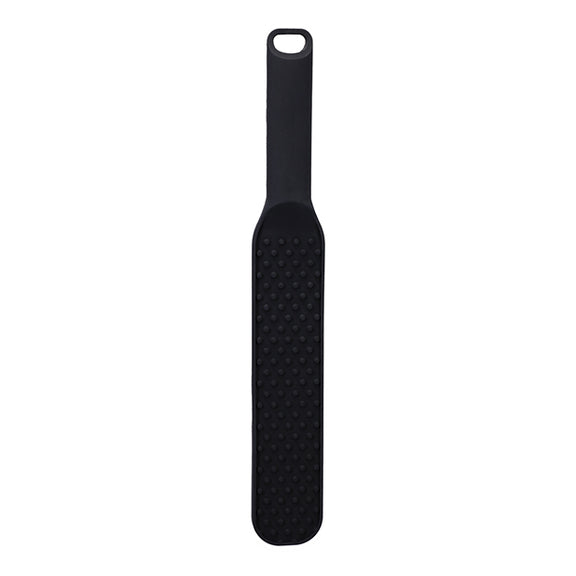 The In A Bag Spanking Paddle in front of a plain white background. There are raised bumps all along the spanking surface of the paddle to add intensity. | Kinkly Shop