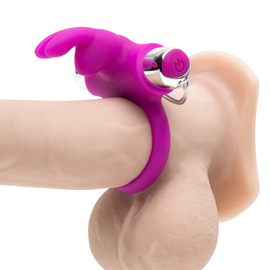 The Happy Rabbit Remote Control Ring wrapped around the base of a dildo, showcasing how the rabbit "nose" and "ears" protrude from the ring to pleasure a nearby partner. | Kinkly Shop