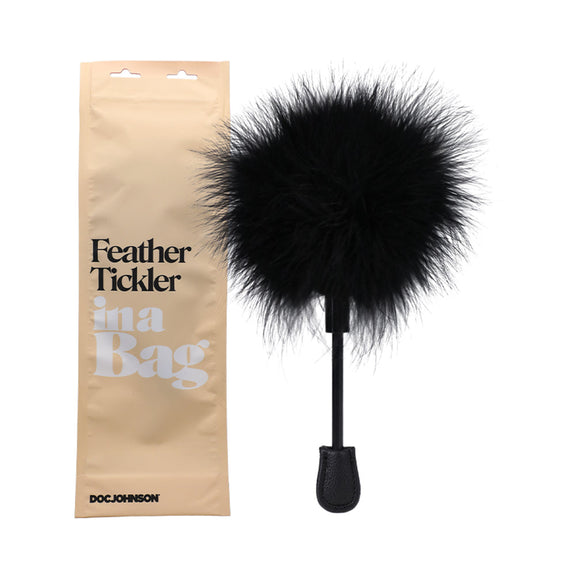 The Doc Johnson Feather Tickler In A Bag shown next to the bag it comes in | Kinkly