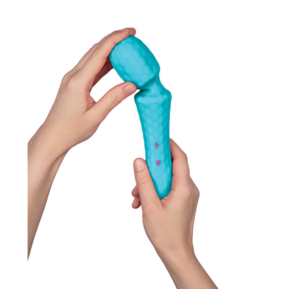 Two hands hold the Femme Funn Ultra Wand. One hand bends the head of the massager to the side, showcasing the flexibility of the head attached to the handle. | Kinkly