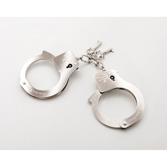 The Fifty Shades Metal Handcuffs in front of a plain white background | Kinkly