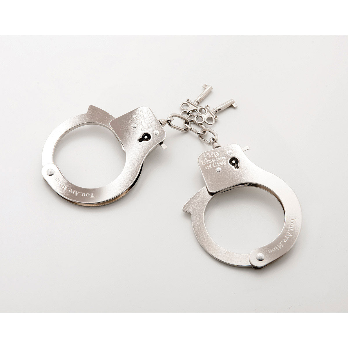 The Fifty Shades Metal Handcuffs in front of a plain white background | Kinkly