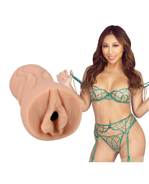 Nicole Doshi is looking into the camera while wearing lingerie. The Signature Strokers - Nicole Doshi stroker is shown next to the porn star. | Kinkly Shop