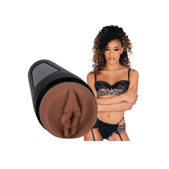 Scarlit Scandal is wearing lingerie and staring at the camera. The Main Squeeze - Scarlit Scandal stroker is shown nearby, next to the porn star. | Kinkly Shop