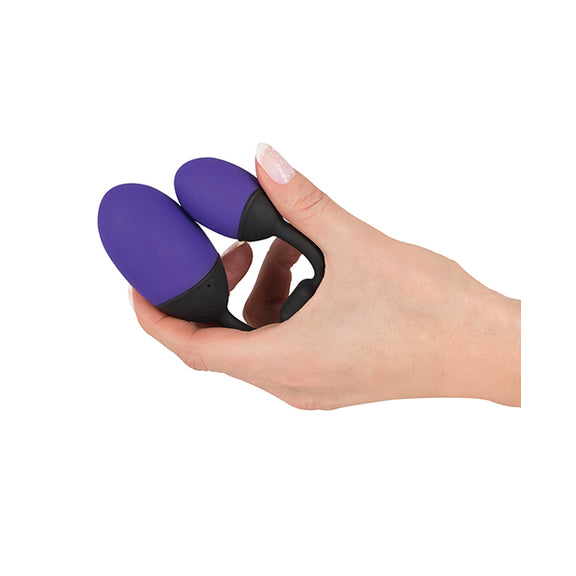 A hand holds the GoGasm Vibrating Pussy & Ass Balls. The balls fold up easily until they're touching one another. The toy fits comfortably in the U-shape between the person's pointer and thumb fingers. | Kinkly Shop