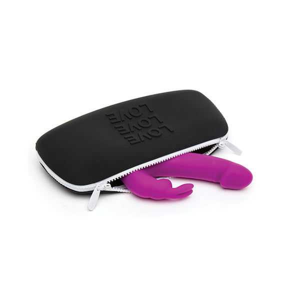 The Love Medium Silicone Storage Bag lays on its side. A full-sized rabbit vibrator is spilling out of it. The vibrator is big and it barely fits into the bag. | Kinkly Shop