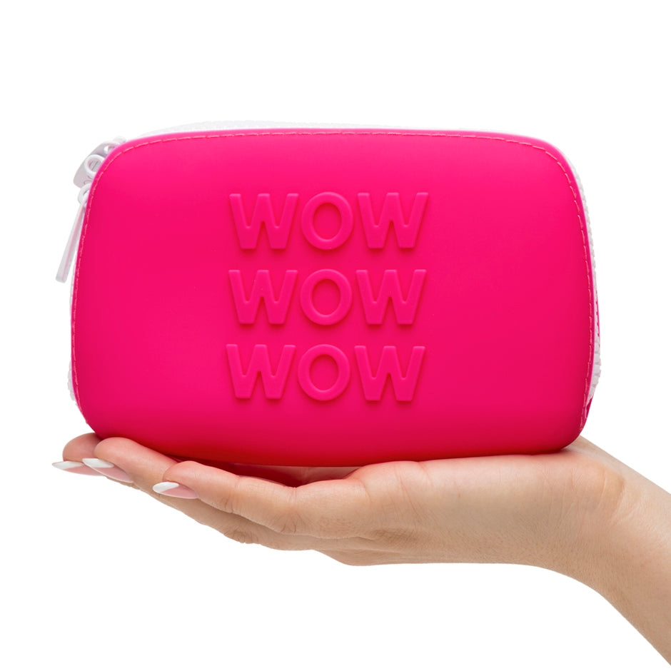 A hand holds the Wow Small Silicone Storage Bag. The bag is about as long as an outstretched palm. | Kinkly Shop