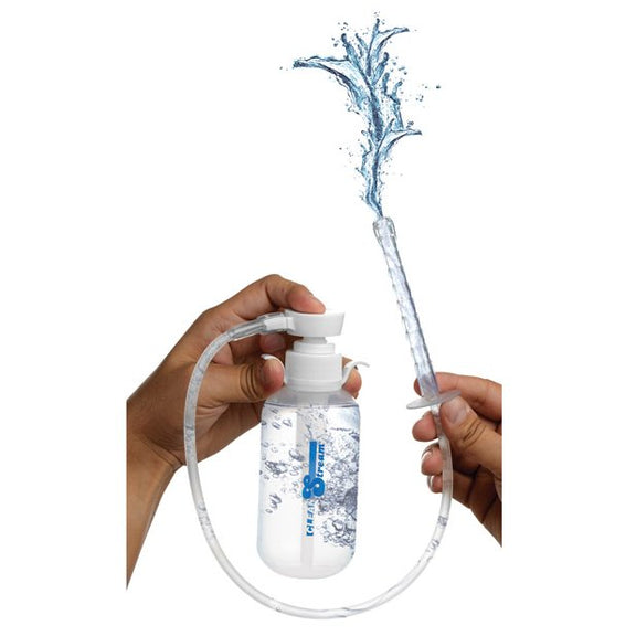 A person holds the CleanStream Pump Action Enema Bottle while pushing down the pump top, squirting water out the top of the nozzle | Kinkly Shop