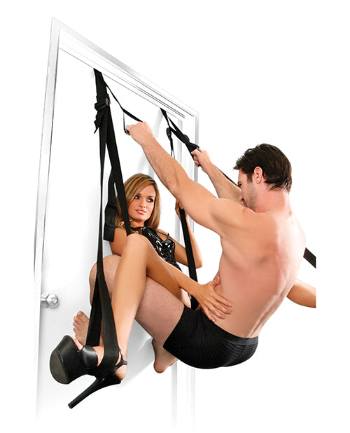 A person in lingerie sits in the Fetish Fantasy Series Deluxe Door Swing with their legs spread. The penetrating partner is squatting with their legs on the door, their hands gripping the hand grips for a very athletic sex position. | Kinkly Shop