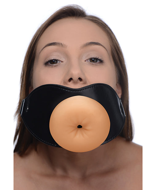 A person wears the Master Series Ass Face, showcasing the anal entrance built into the TPE sleeve of the gag's entrance. | Kinkly Shop