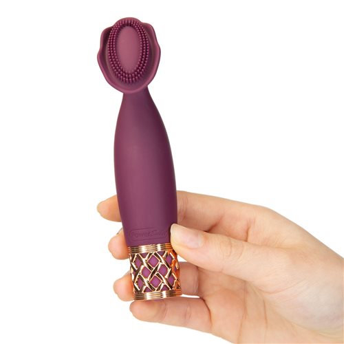 A hand holds the Pillow Talk Secrets Passion, facing the unique flower-shaped head towards the camera. The vibrator looks like it's slightly longer than the person's outstretched palm. | Kinkly Shop