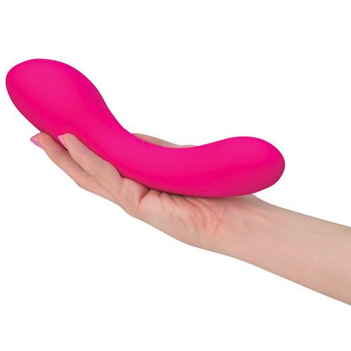 A person holds the The Swan vibrator in their hand. It looks particularly thick and long in their hand. | Kinkly Shop