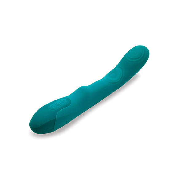 The Nu Sensuelle Vivi Tapping Vibe lays out on a table. There's a clitoral bump near the control panel at the base. There are three buttons at the base of the vibrator that control the sensations. | Kinkly Shop