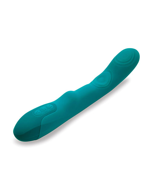 The Nu Sensuelle Vivi Tapping Vibe lays out on a table. There's a clitoral bump near the control panel at the base. There are three buttons at the base of the vibrator that control the sensations. | Kinkly Shop