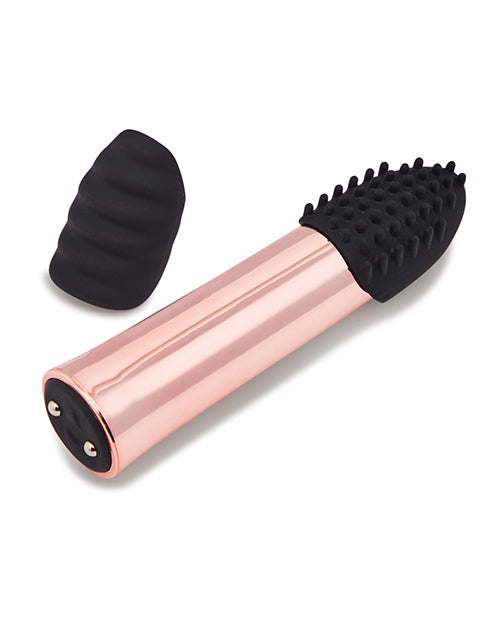 The Point Plus Rechargeable vibrator laying on its side next to one of the extra tips for the tip of the vibe. | Kinkly Shop