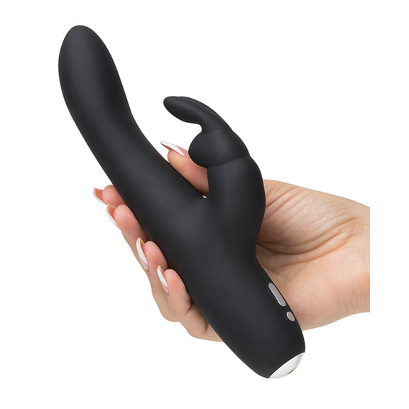 The Greedy Girl Rechargeable Slimline is being held in someone's hand. The shaft looks surprisingly slender compared to most rabbit vibrators. The base of the vibrator has a rounded base. | Kinkly Shop