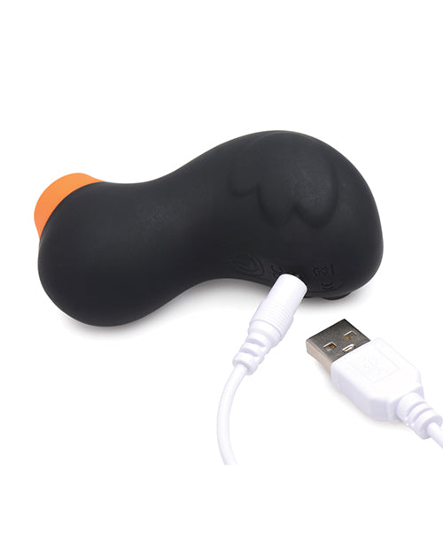The backside of the Inmi Shegasm Sucky Ducky with the charging cable plugged into the duck. It's a pin charger that plugs into the duck. | Kinkly Shop