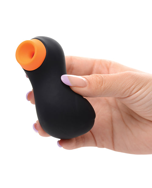 A hand holds the Inmi Shegasm Sucky Ducky. It's a very small toy, and it looks like the sex toy could fit inside of the person's palm with the fingers wrapped around the toy to hide it. | Kinkly Shop