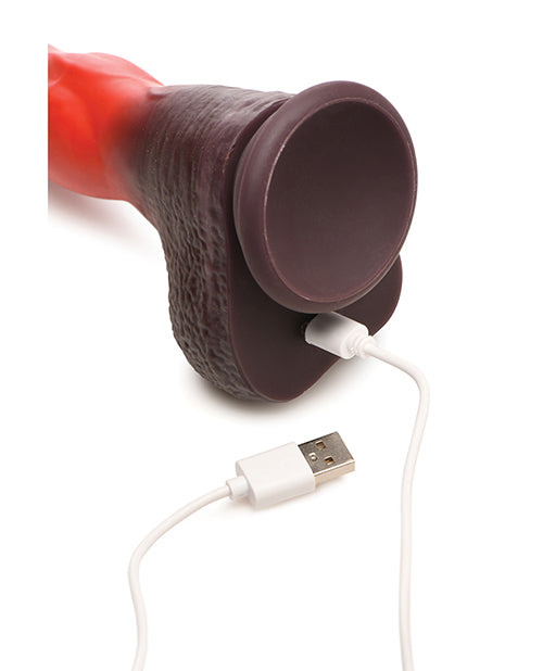 The Creature Cocks Ramming Hound with Remote Control shown with the charging cord plugged in to charge it. The charger plugs in underneath the dildo right under where the balls are. | Kinkly Shop