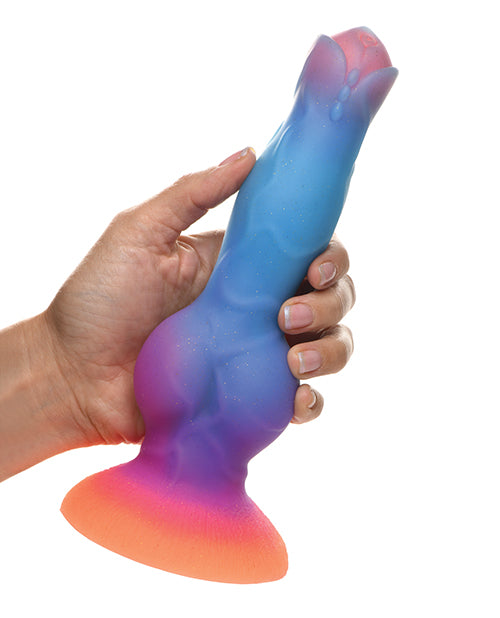 A hand holds the Creature Cocks Space Cock. The knot at the base looks very thick, but the shaft itself looks somewhat close to a biological penis. | Kinkly Shop
