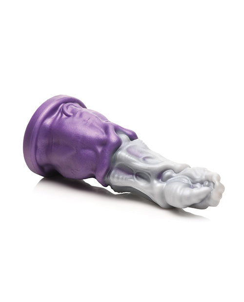 The Creature Cocks Grim Reaper resting sideways, showcasing how thick the base of the dildo is. The flared base is not very flared for this toy and it barely extends past the thickest diameter of the dildo. | Kinkly Shop