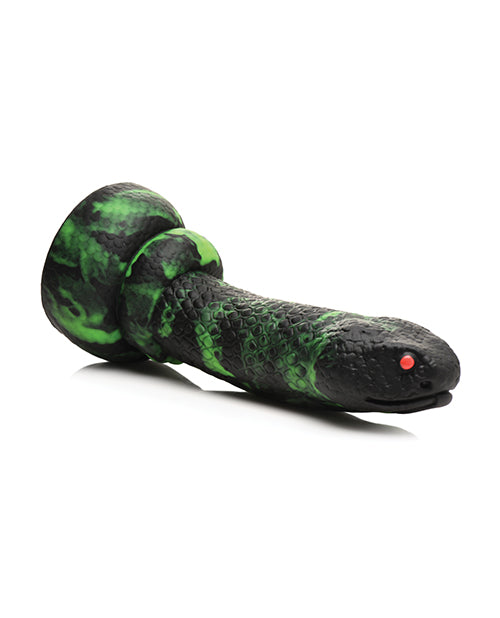 The Creature Cocks Python laying on the ground. The dildo has white space underneath it, showcasing the firmness and ability of the dildo to hold its shape. | Kinkly Shop