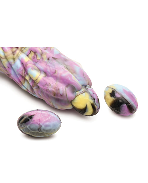 Close-up of the tip of the Creature Cocks Dragon Spawn Ovipositor with Eggs shown laying an egg. The included silicone eggs will slide though the dildo's internal tunnel with help of lube. | Kinkly Shop