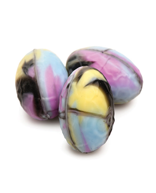 Close-up on the silicone eggs. They have a visible seam running length-wise in the middle of each egg, and the colors match the colors of the dildo. | Kinkly Shop