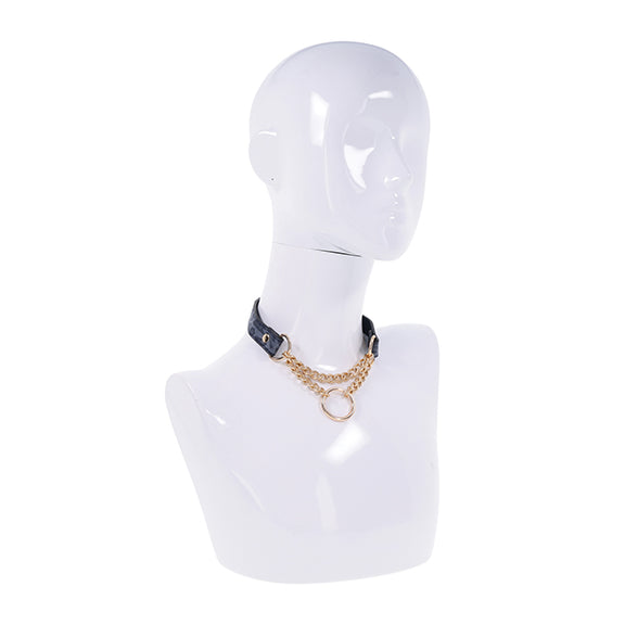 A mannequin wears the Sportsheets Cougar Day Collar. The O-ring and chains hang in the front, looking like a piece of gorgeous statement jewelry in addition to being a collar. | Kinkly Shop