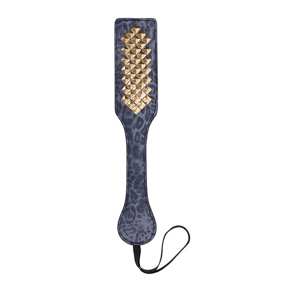 Top down view of the Sportsheets Cougar Studded Paddle. The gold spikes along the spanking surface of the paddle really stand out along the length of the paddle. | Kinkly Shop