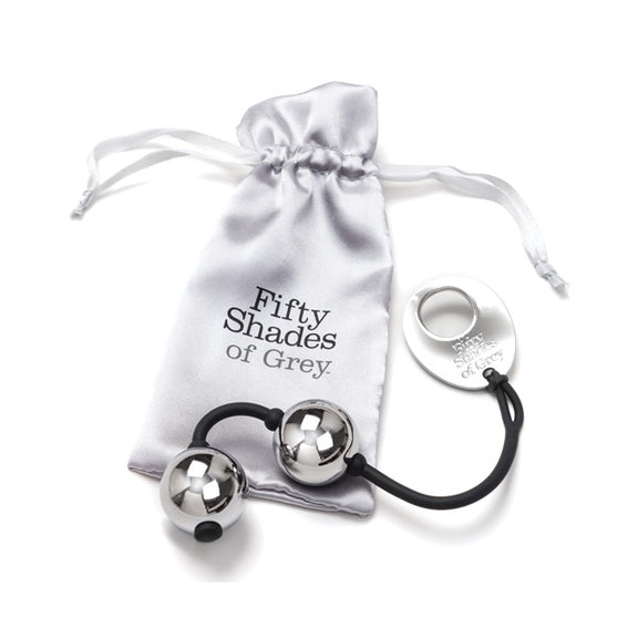 The Fifty Shades of Grey Inner Goddess Kegel Balls sitting out on top of the silver drawstring storage bag that it comes with to work for storage. | Kinkly Shop