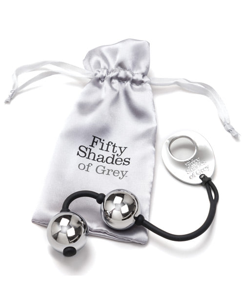 The Fifty Shades of Grey Inner Goddess Kegel Balls sitting out on top of the silver drawstring storage bag that it comes with to work for storage. | Kinkly Shop