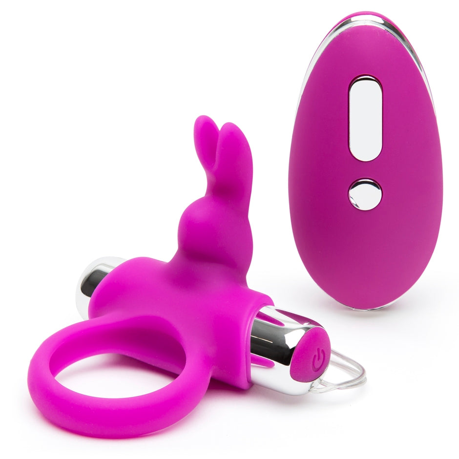 The Happy Rabbit Remote Control Ring resting next to the oval-shaped remote control that controls the vibrations of it. | Kinkly Shop