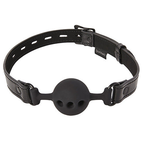 Sportsheets Saffron Breathable Ball Gag in front of a plain white background. The ball itself has three holes in it to make it easier to breathe through. | Kinkly Shop