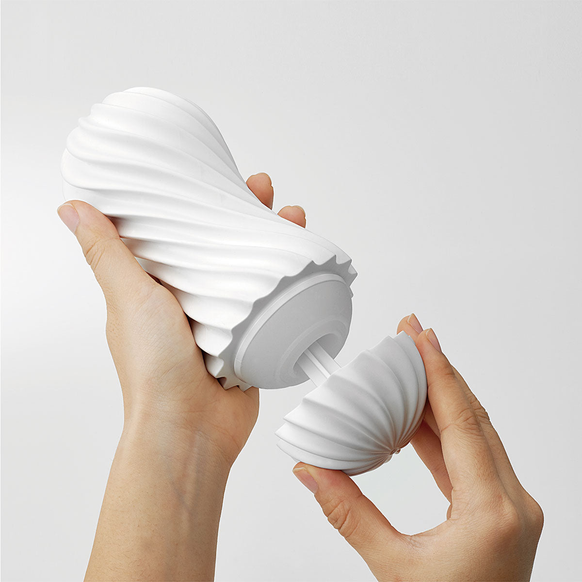 Two hands open the TENGA Flex, pulling the lid off of the stroker itself. | Kinkly Shop