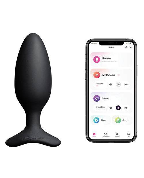 The Lovense Hush 2 shown next to a cell phone. The cell phone has the free cell phone app open. This app can control the butt plug. | Kinkly Shop