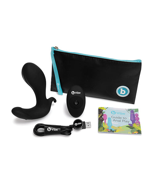 The b-Vibe Expand shown with everything that comes with it. There's the plug itself, the remote, the zippered storage pouch, a guide to anal play, and the charging cable. | Kinkly