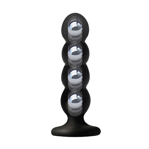 An X-Ray image of the VERS Suction Plug, showcasing the four weighted balls that are hidden inside of the plug for additional sensation. | Kinkly