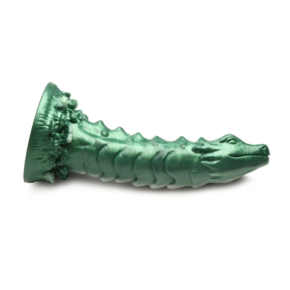 The Creature Cocks Cockness Monster shown laying on its side. It looks like a sea dragon, complete with face as the tip of the dildo. | Kinkly Shop
