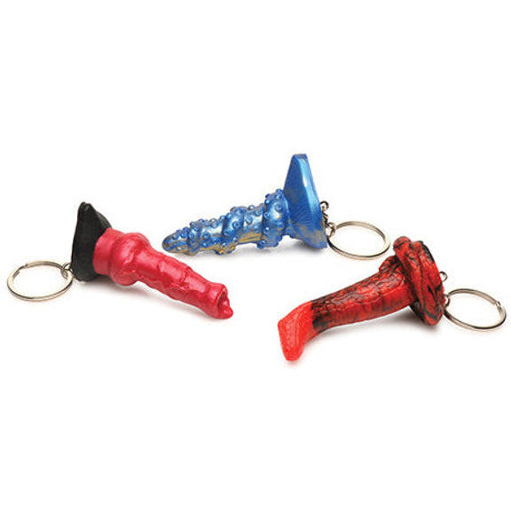 The Creature Cocks Fantasy Dildo Keychain Set laid out on their sides. The keychain loops are clearly visible poking out from each dildo's base. | Kinkly Shop