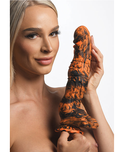 A person holds the Creature Cocks Sabertooth in their hands. The dildo looks somewhat thick, but it looks VERY long. | Kinkly Shop