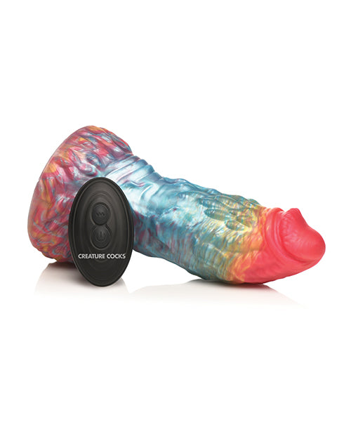 The Creature Cocks Phoenix Vibrating Remote-Control Dildo resting on its side, shown next to the remote control that's laying up against it. The remote is oval shaped and would fit into the palm of someone's hand. | Kinkly Shop