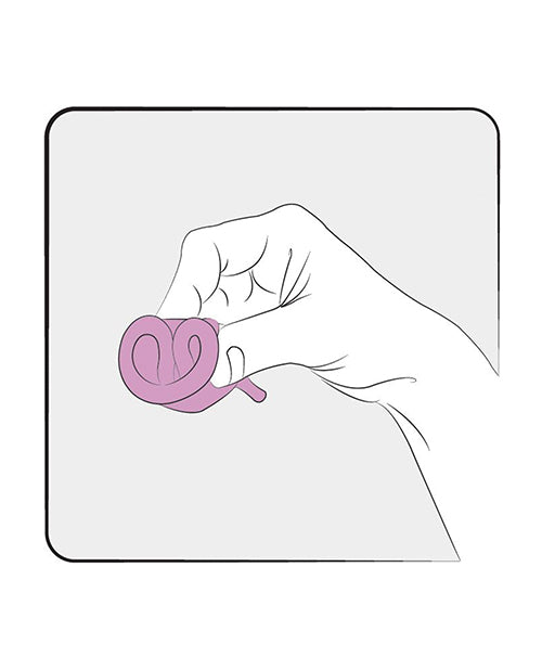 The FEMINTIMATE Eve Menstrual Cup rolled into a smaller size to insert it. | Kinkly Shop