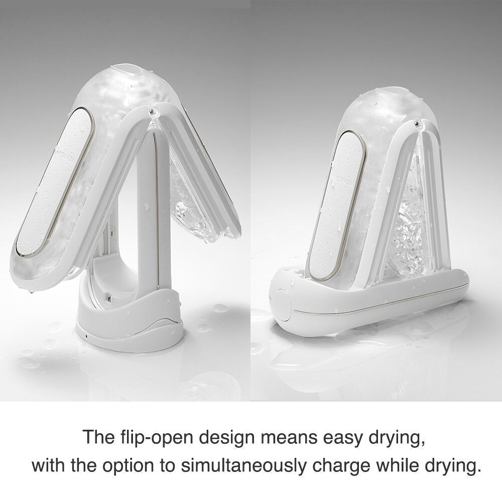 The TENGA Flip Zero Vibrating shown flipped open, showcasing how the case offers easier air drying. Text on the image reads: The flip-open design means easy drying with the option to simultaneously charge while drying. | Kinkly