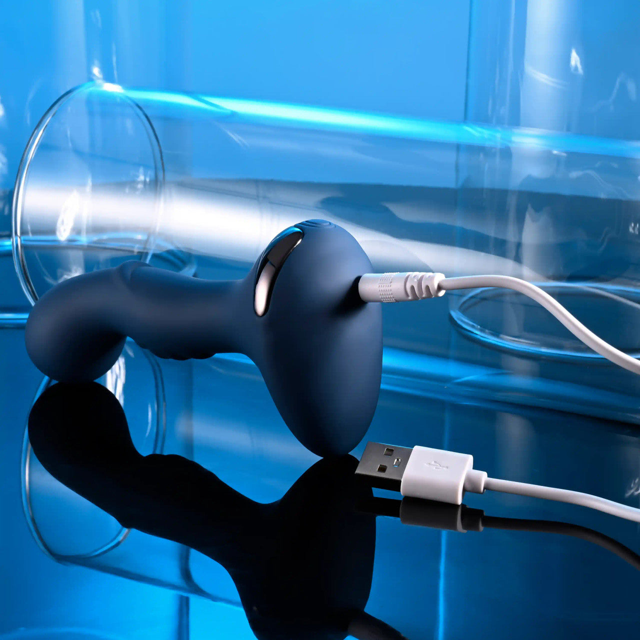 Close-up on the base of the Zero Tolerance Blue Oasis which is plugged into a charging cable. | Kinkly Shop