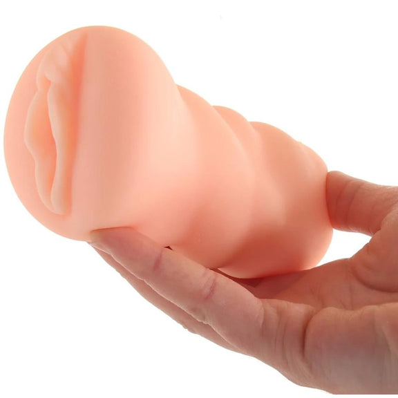 A hand holds the Brooklyn Chase Pussy stroker. It looks slender in their hand - like they could overwrap their fingers around it. | Kinkly Shop