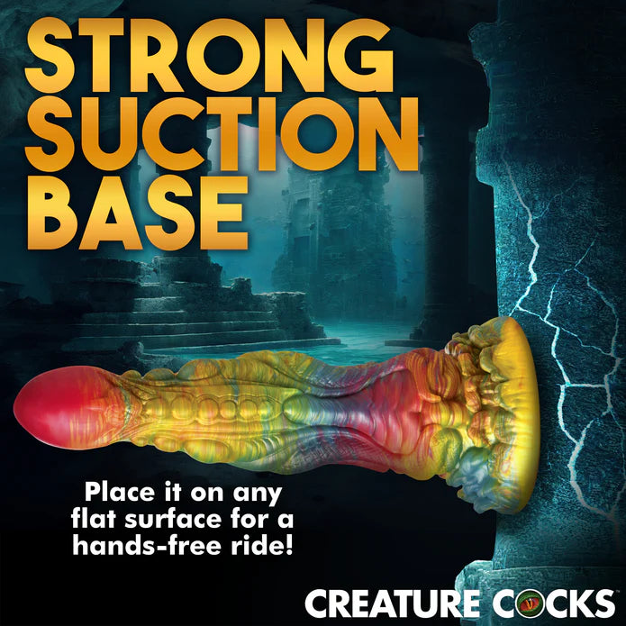 The Creature Cocks Majestic Merman shown adhered to a vertical surface. Text on the image reads: Strong suction base. Place it on any flat surface for a hands-free ride. | Kinkly