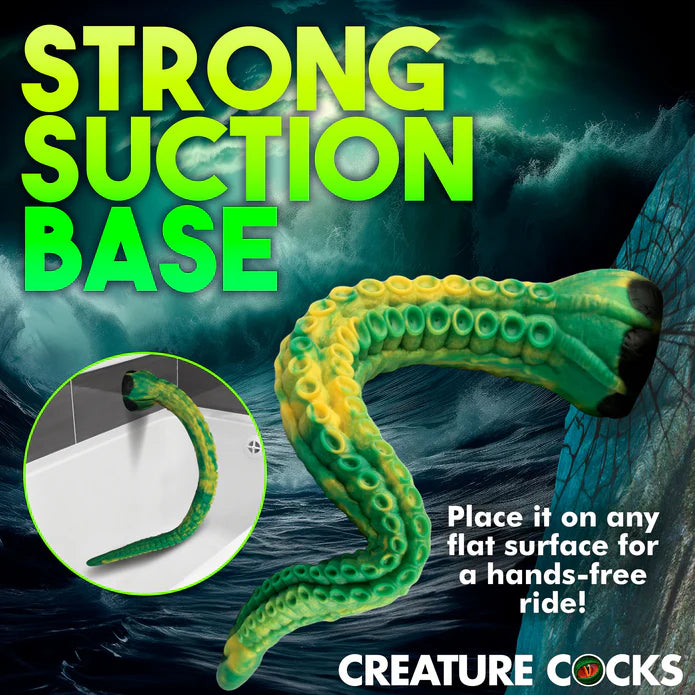 The Creature Cocks Titan shown suction cupped to a broken rock. The text reads: Strong suction base. Place it on any flat surface for a hands-free ride. | Kinkly Shop