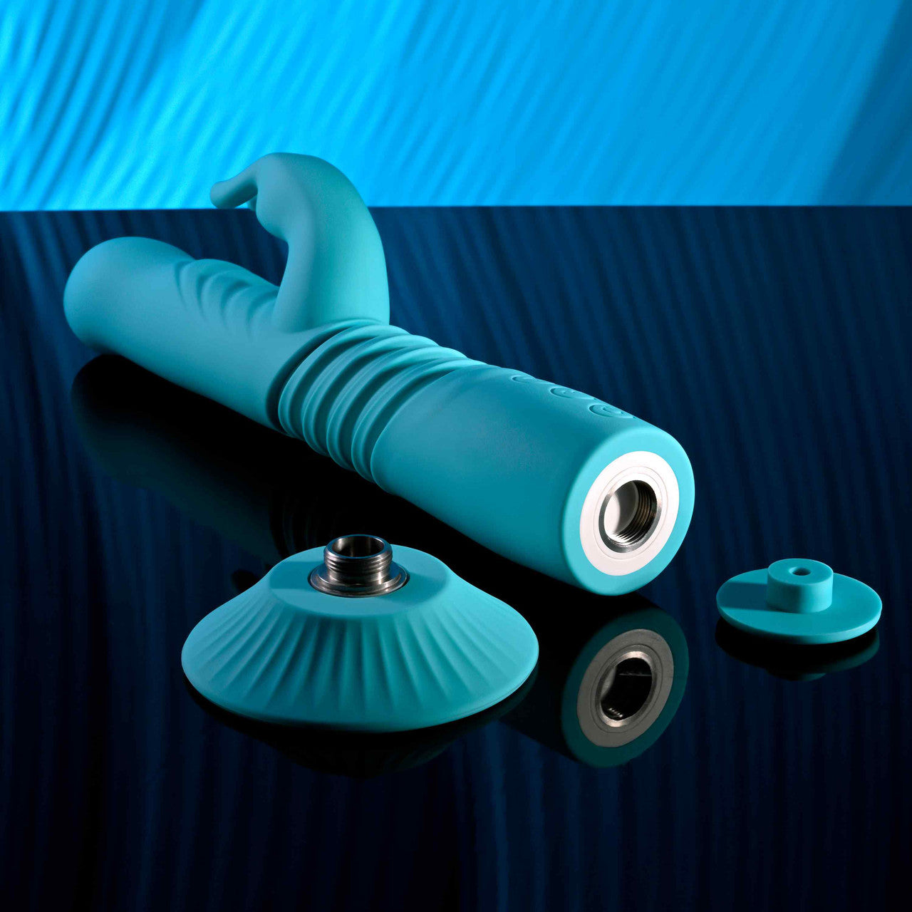 The Evolved Bunny Hop shown next to the suction cup base that can be screwed into the base of the vibe. This allows it to pleasure hands-free. | Kinkly