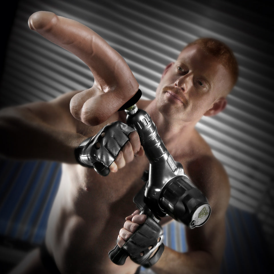 A person handholds the Fort Troff Gunner System. They're gripping both of the handles, showcasing how the sex machine can be used handheld. | Kinkly Shop